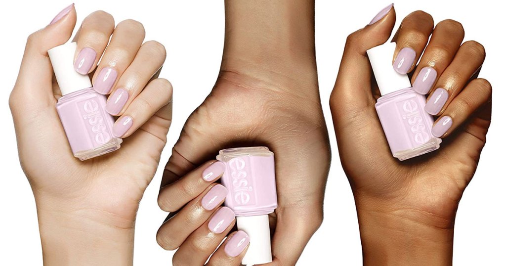 three women's hands with pink nails holding bottles of pink essie nail polish