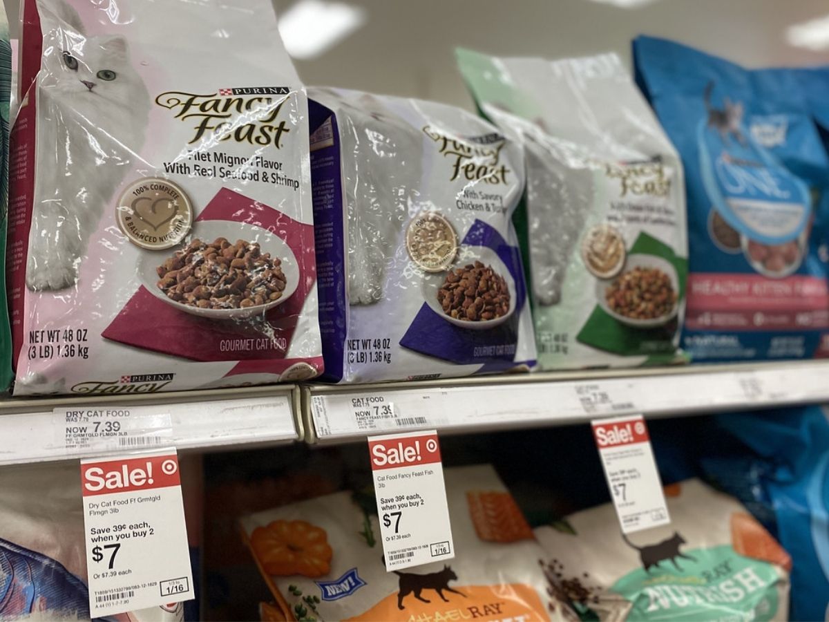 Shelf at store filled with bags of Fancy Feast Dry Cat Food