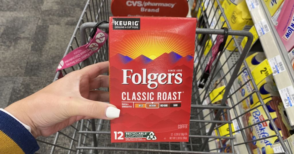 hand holding folgers coffee pods