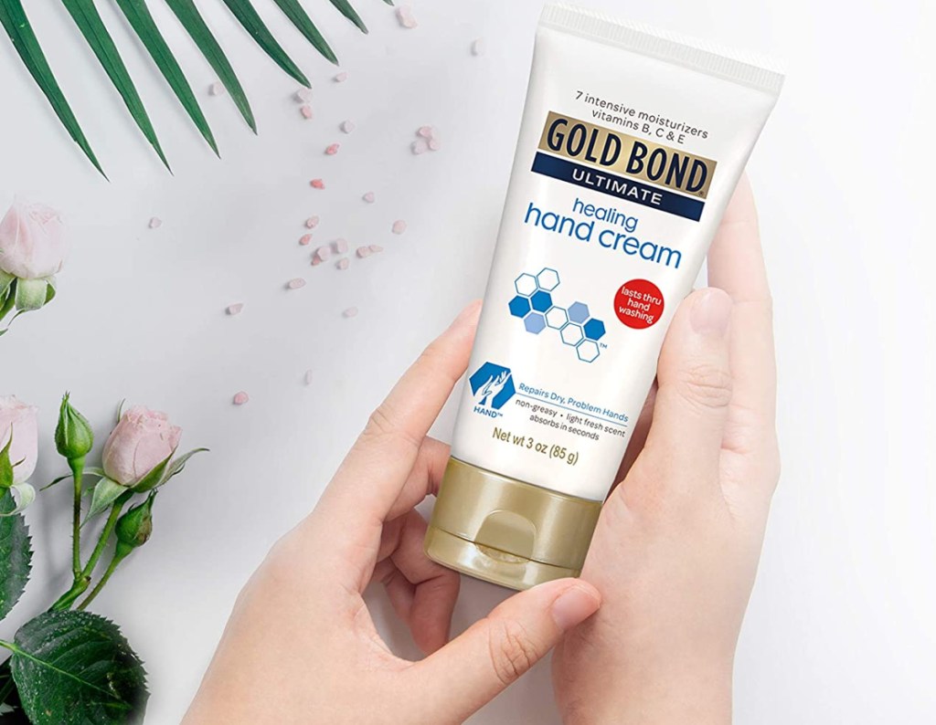 hand holding Gold Bond Ultimate Intensive Healing Hand Cream 3 oz