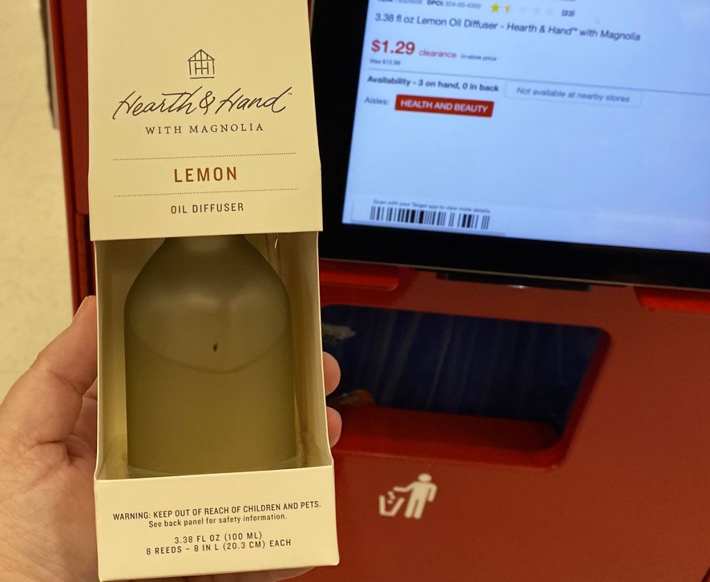 person holding up a lemon scented diffuser at red target price scanner