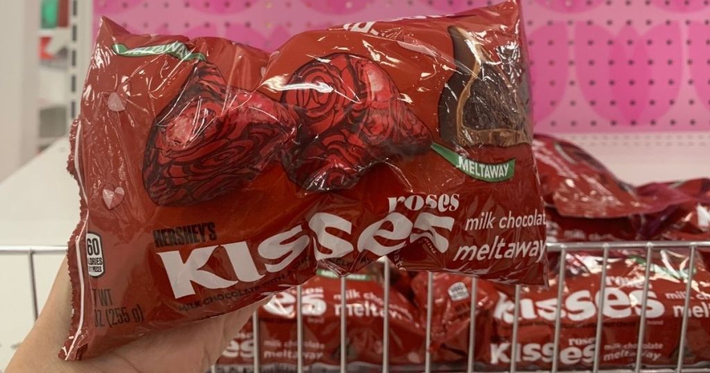 hand holding a bag of Hershey's Roses Kisses