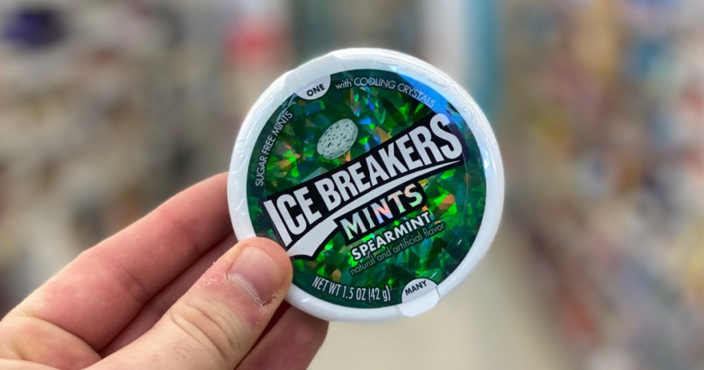 hand holding tin of mints