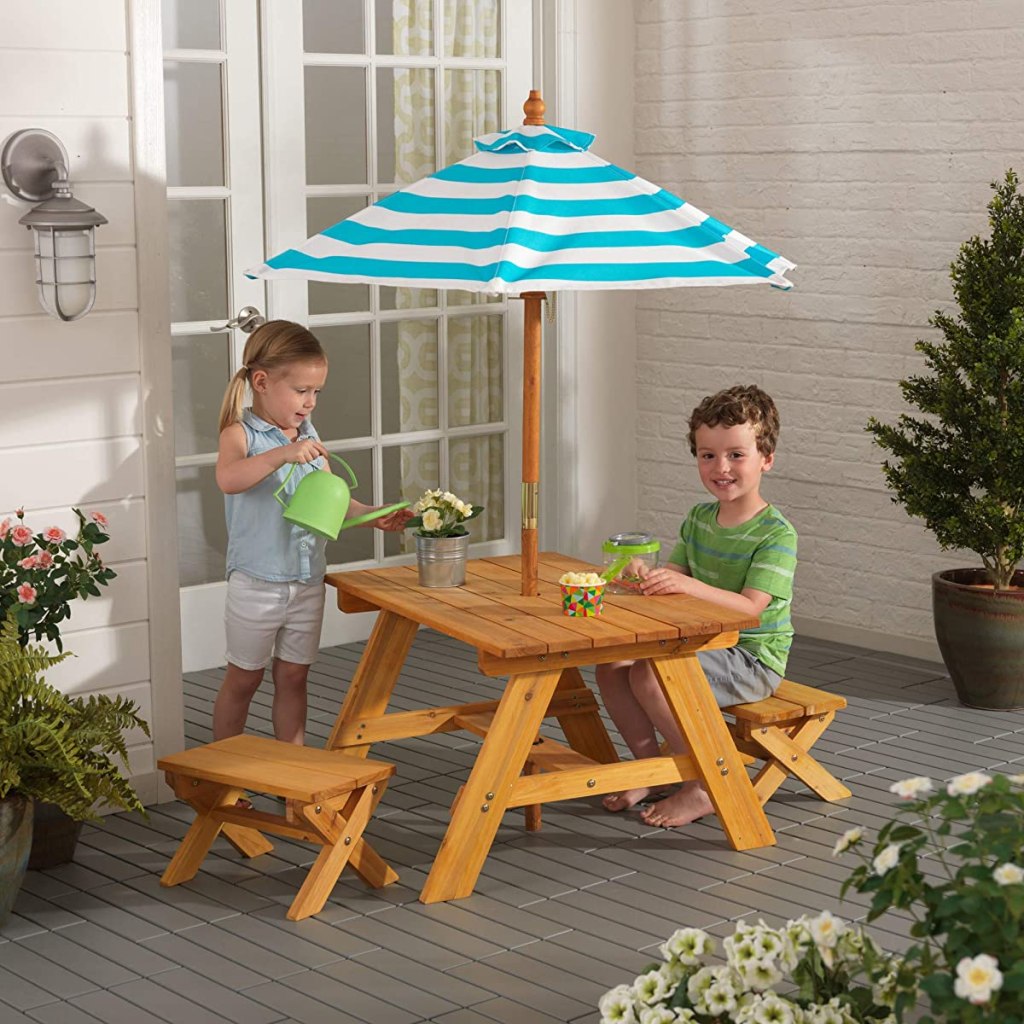 kids sitting at a small outdoor table
