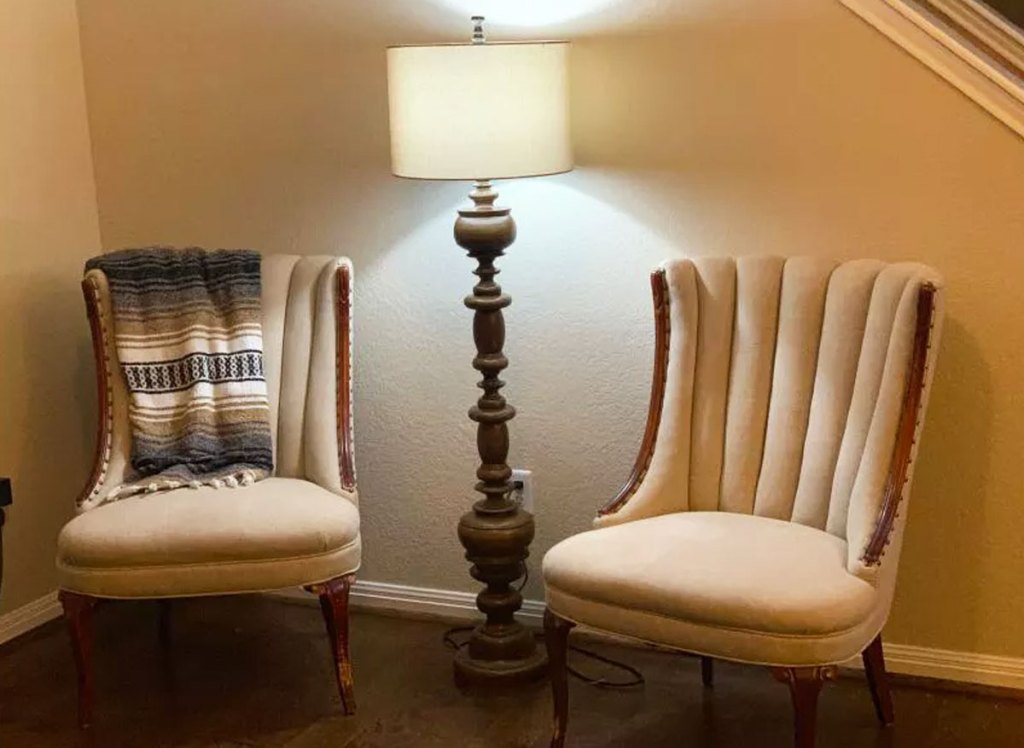 wood floor lamp between two accent chairs