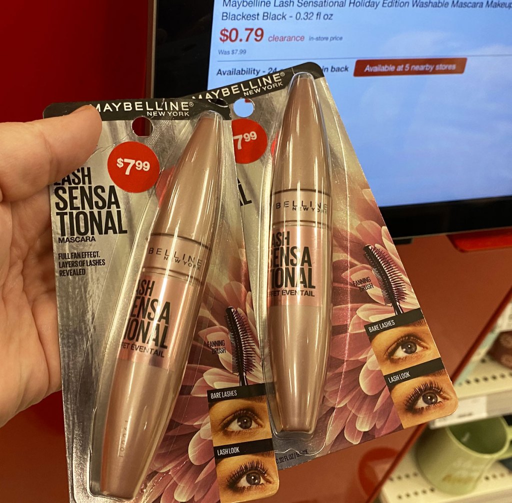 person holding two pink maybelline mascara tubes at target price scanner