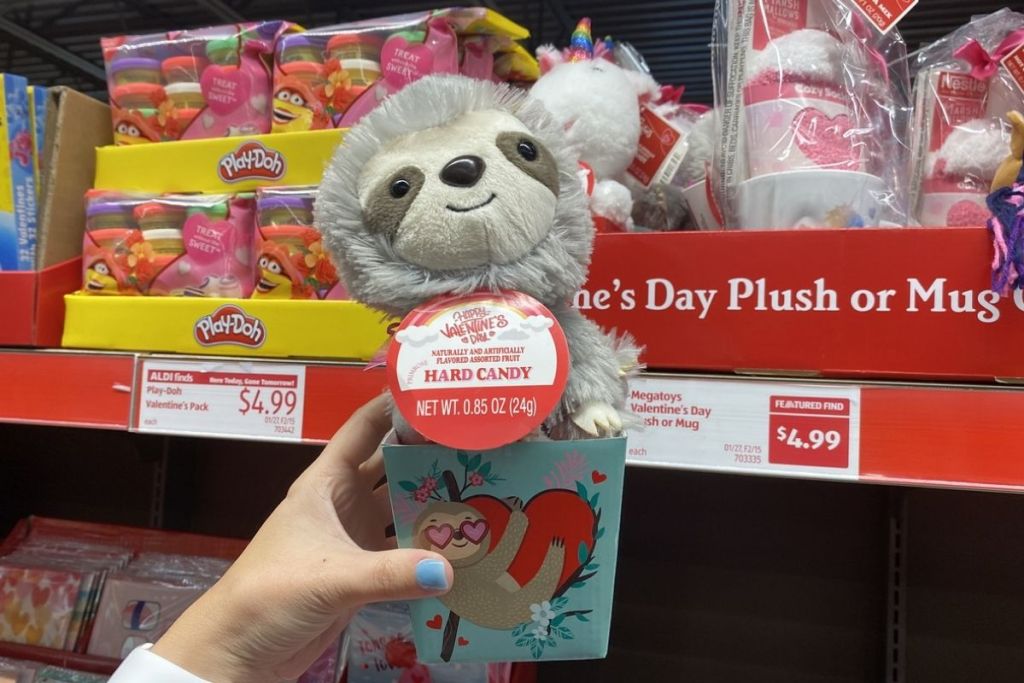 hand holding Megatoys Valentine's Day Sloth or Unicorn Plush and Candy Mug Set