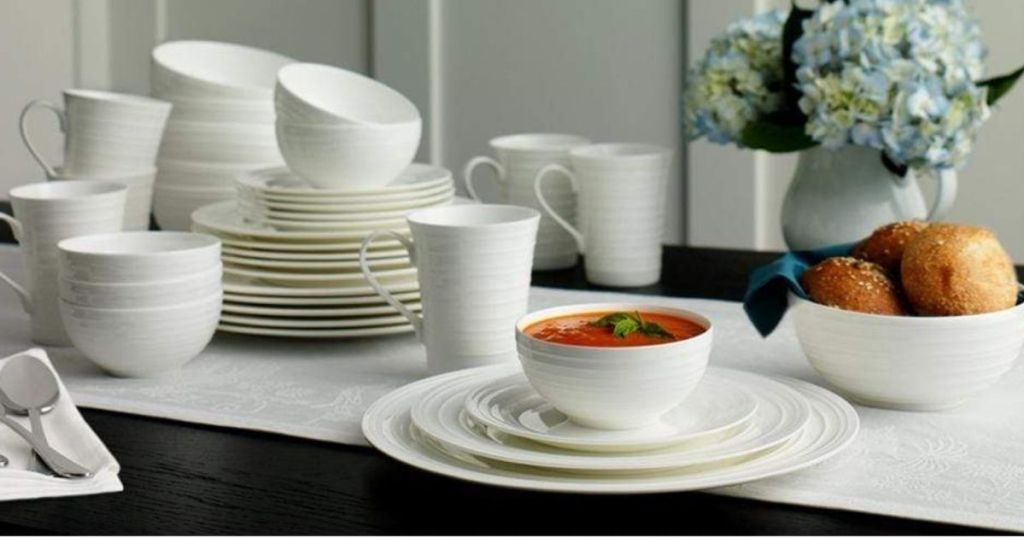 table with mikasa swirl dinnerware set stacked up together