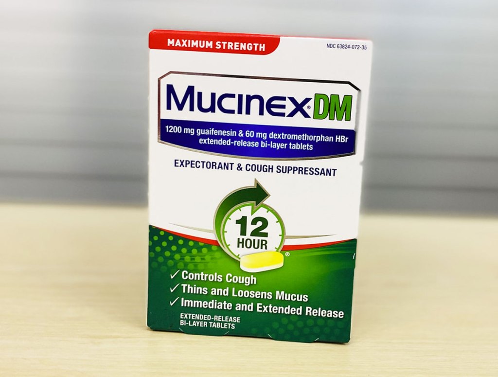 green and white box of Mucinex DM Cough Suppressant tablets