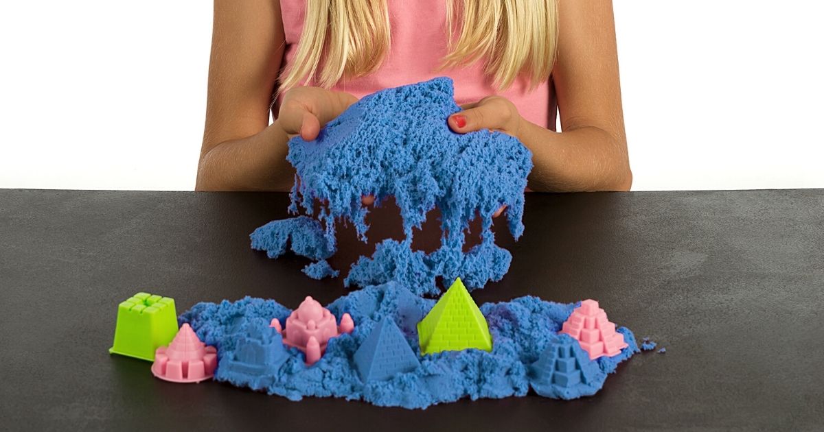 girl playing with blue kinetic sand