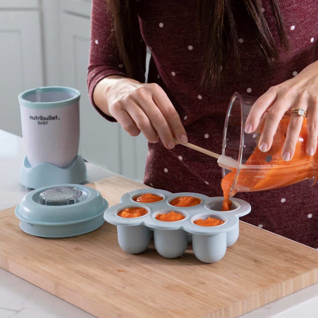 woman prepping baby food with Nutribullet Baby