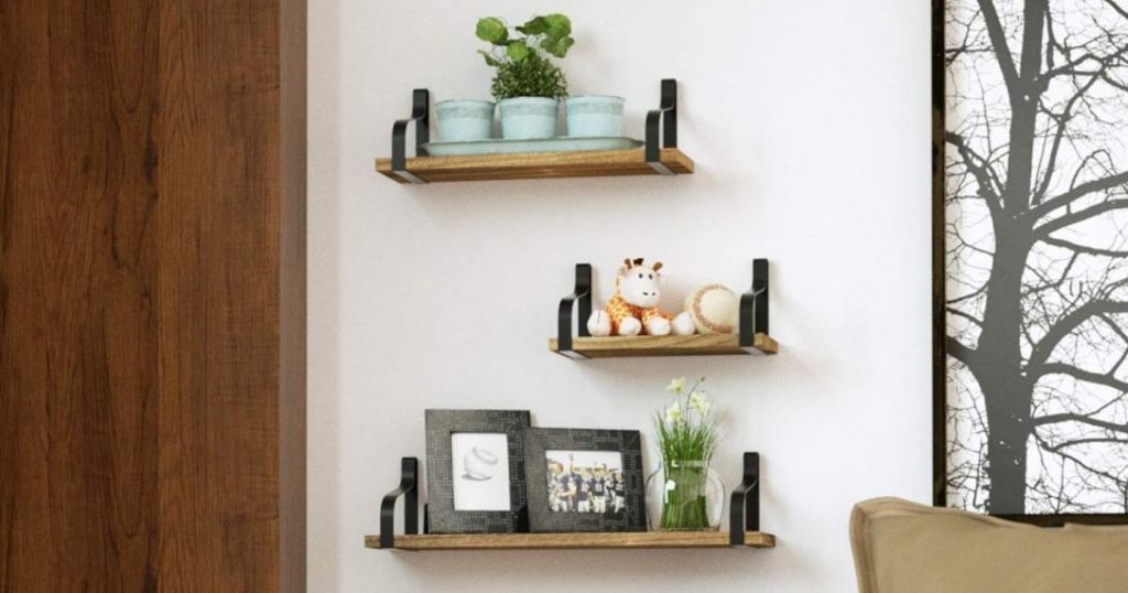 three rustic shelves with decor on them in bedroom