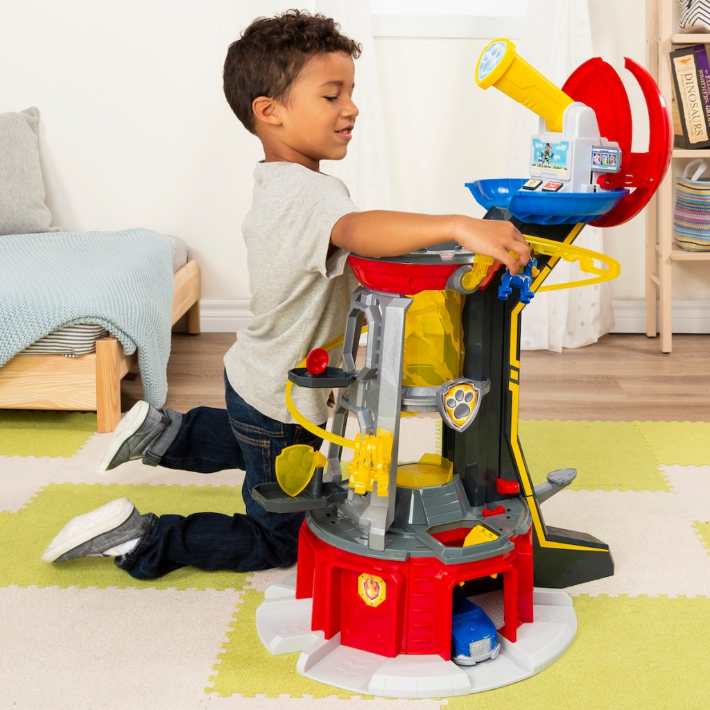 boy playing with PAW Patrol Mighty Pups Super PAWs Lookout Tower Playset with Lights and Sounds