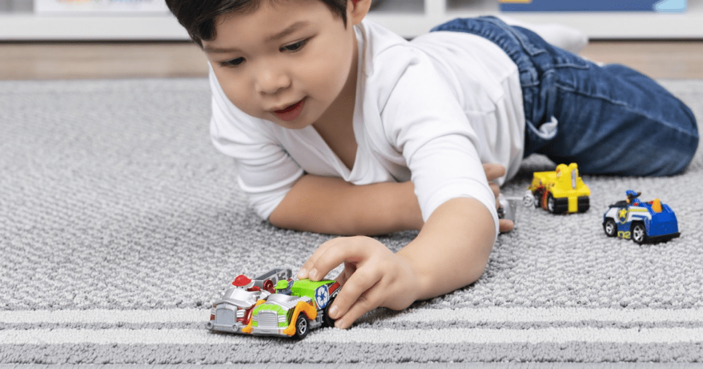 boy playing with Paw Patrol Cars