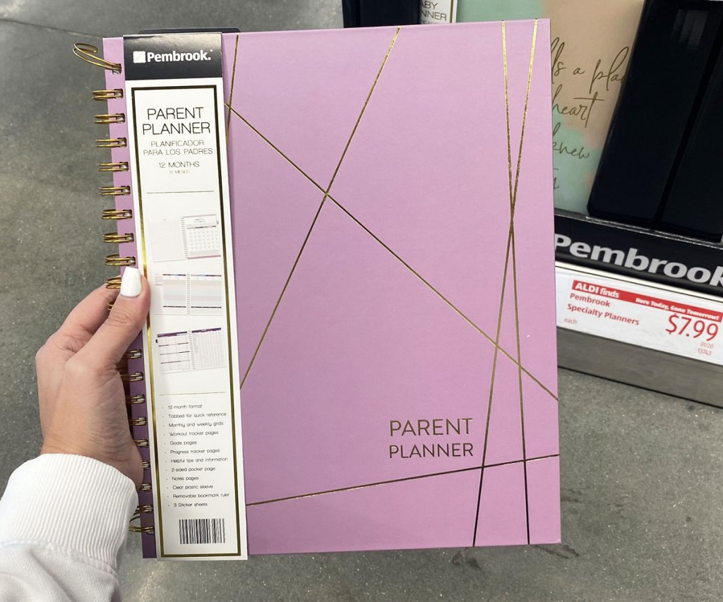 woman holding up purple 12-month parent planner