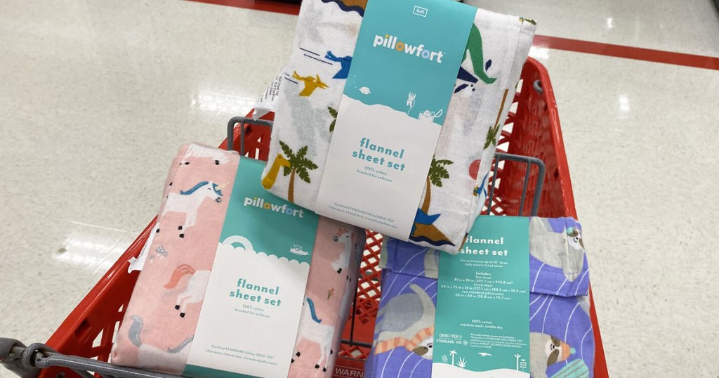 three sets of pillowfort printed flannel sheets inside a red target shopping cart
