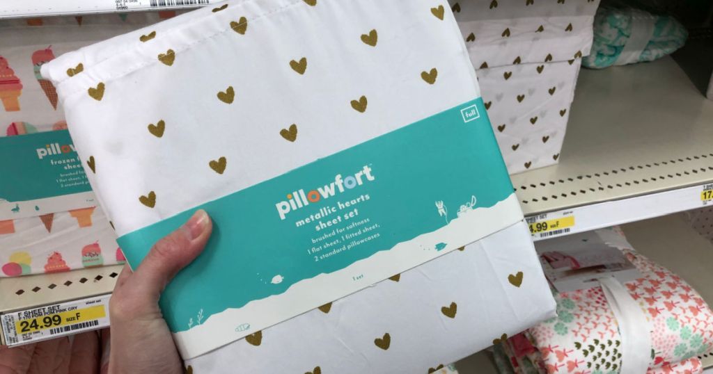 Person holding Pillowfort Hearts Sheet Set inside target store