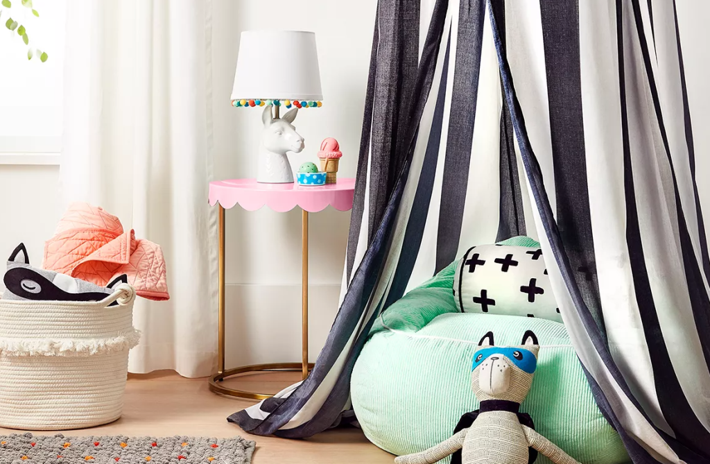 kids bedroom with canopy, table and lamp