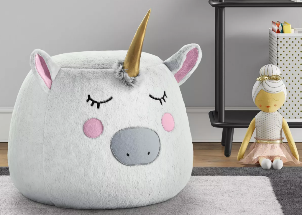 Pillowfort Unicorn Pouf on the floor next to a ballerina toy