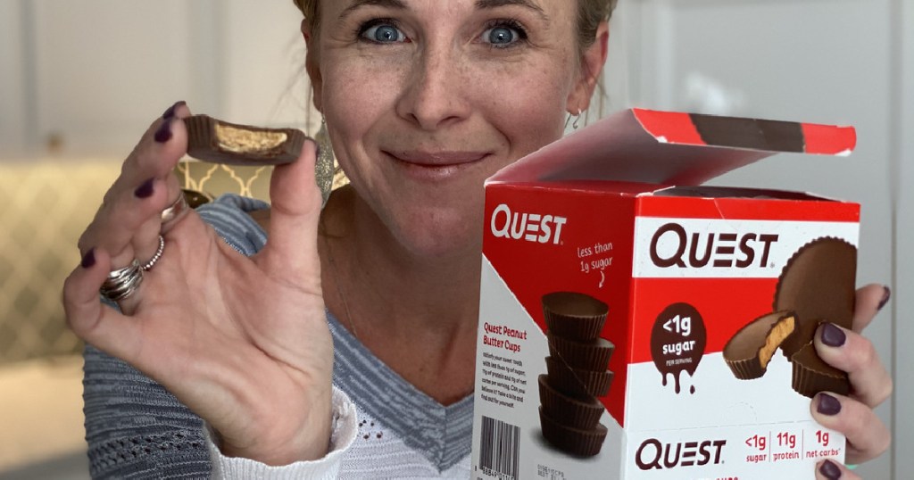 woman holding Quest peanut butter cups