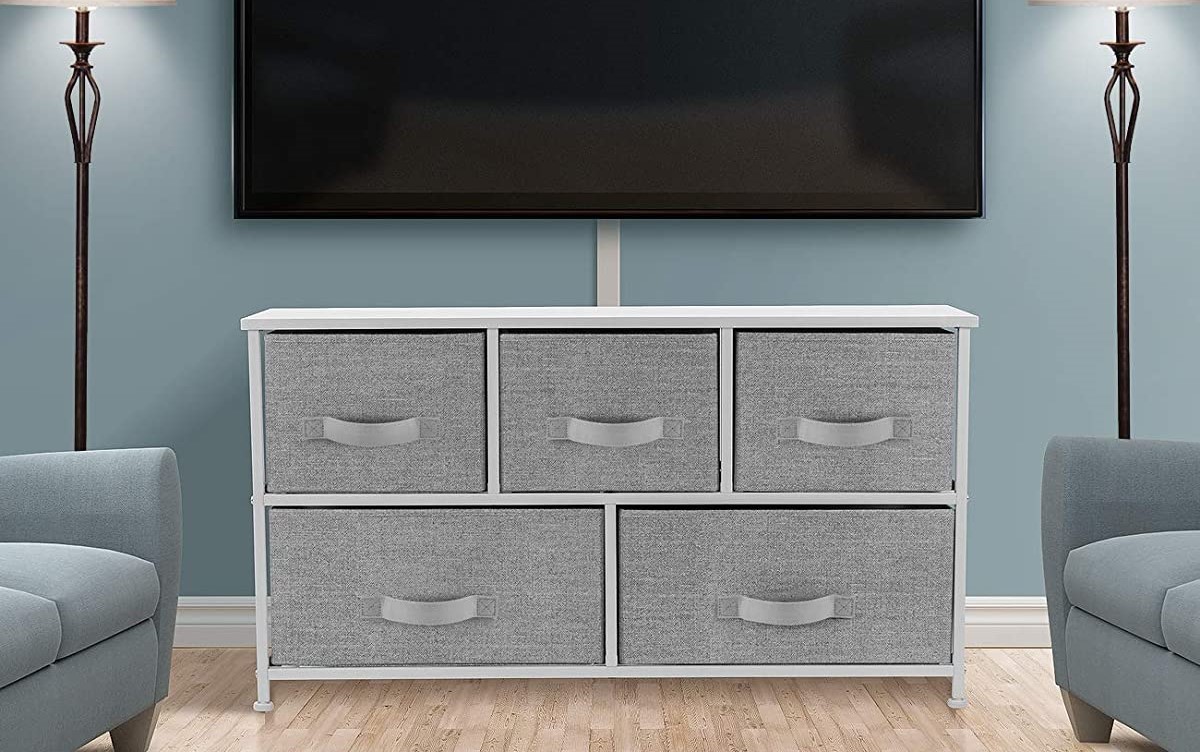 dresser with fabric bins beneath a TV