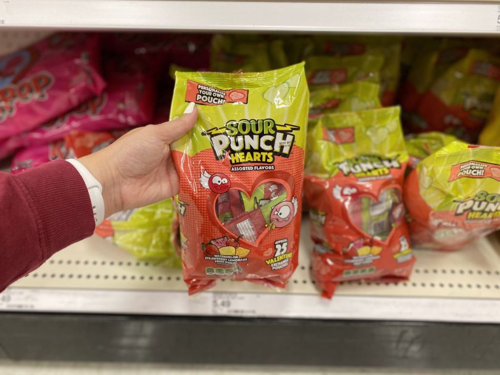 hand holding a bag of Sour Punch Hearts