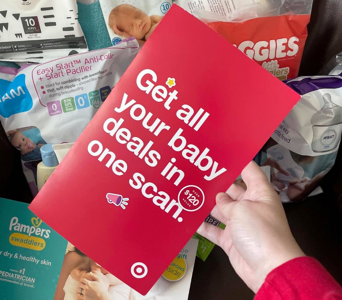 hand holding a Target Baby Registry Coupons book