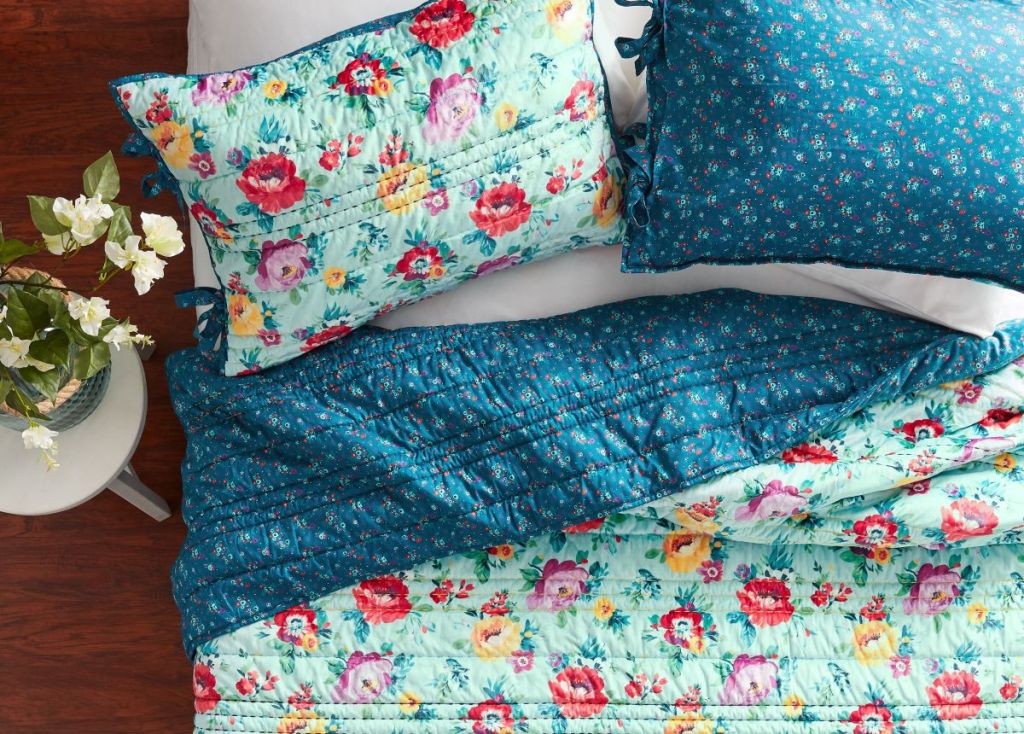 bed with floral quilt and pillows