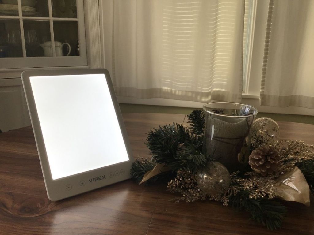 Vipex light therapy lamp on table next to centerpiece