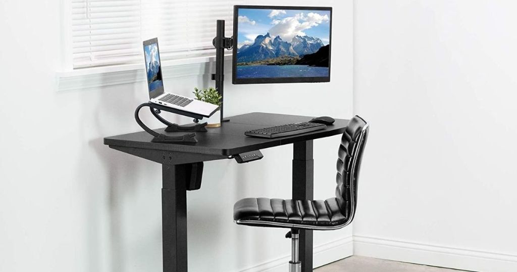 desk with a computer on it and a chair next to it