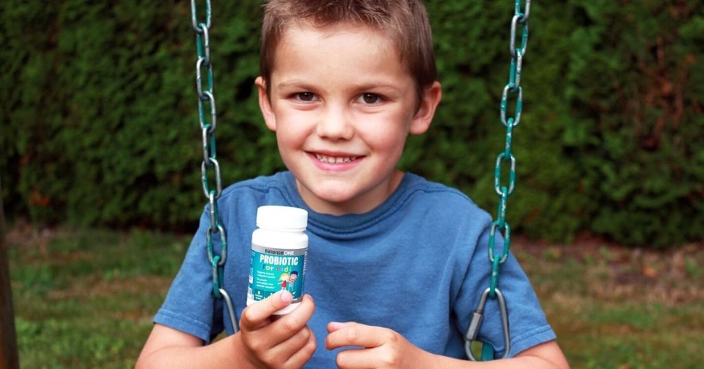 kid holding a bottle of probiotics