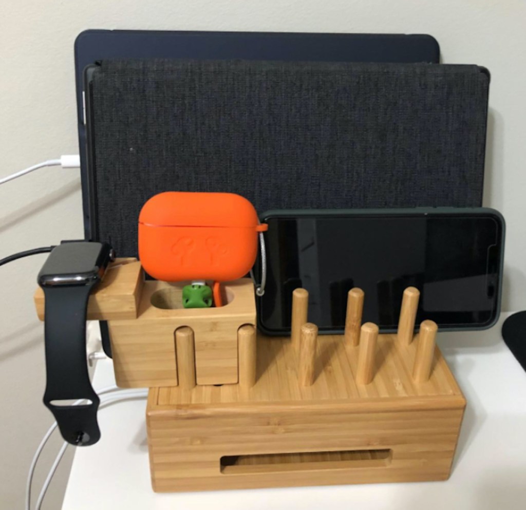 bamboo charging station with apple watch airpods and tablets sitting on top