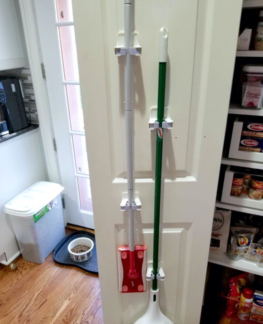 brooms hanging up on back of door is one of our favorite pantry organization ideas