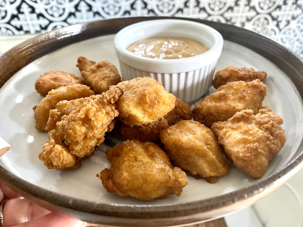 chicken nuggets on plate with honey mustard dipping sauce