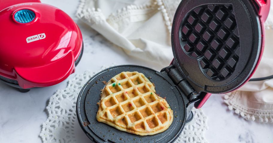 waffle maker open to show heart shaped waffle