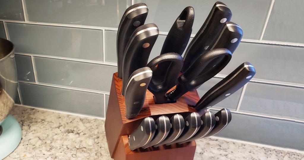 set of kitchen knives in wood block on kitchen counter