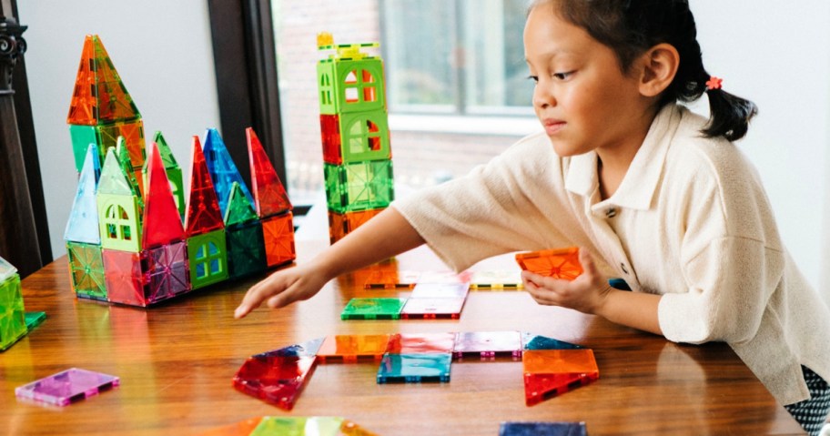 girl playing with magna-tiles on table