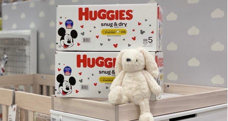 huggies snug & dry diapers stacked on top of a crib