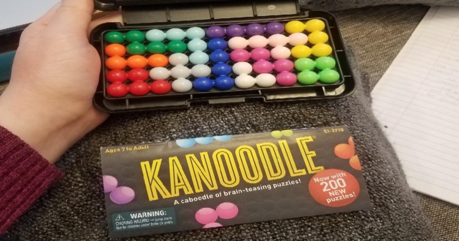 hand holding box of kanoodle game