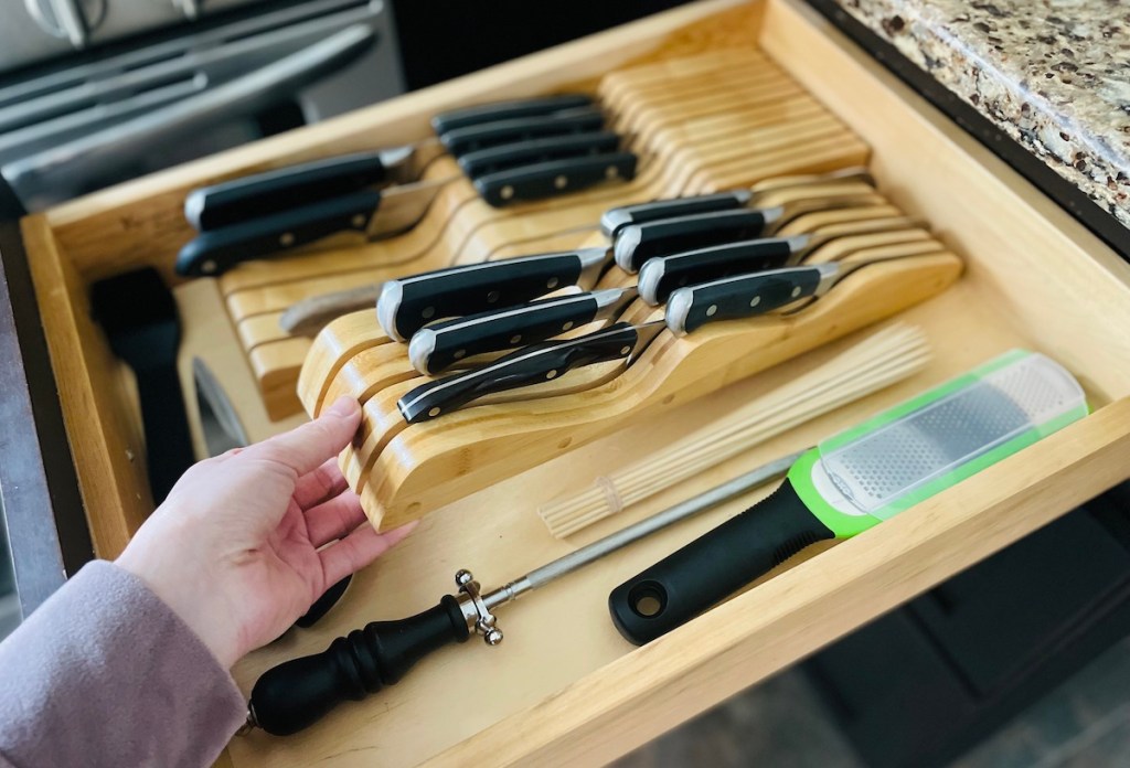 hand holding bamboo wood knife drawer organizer