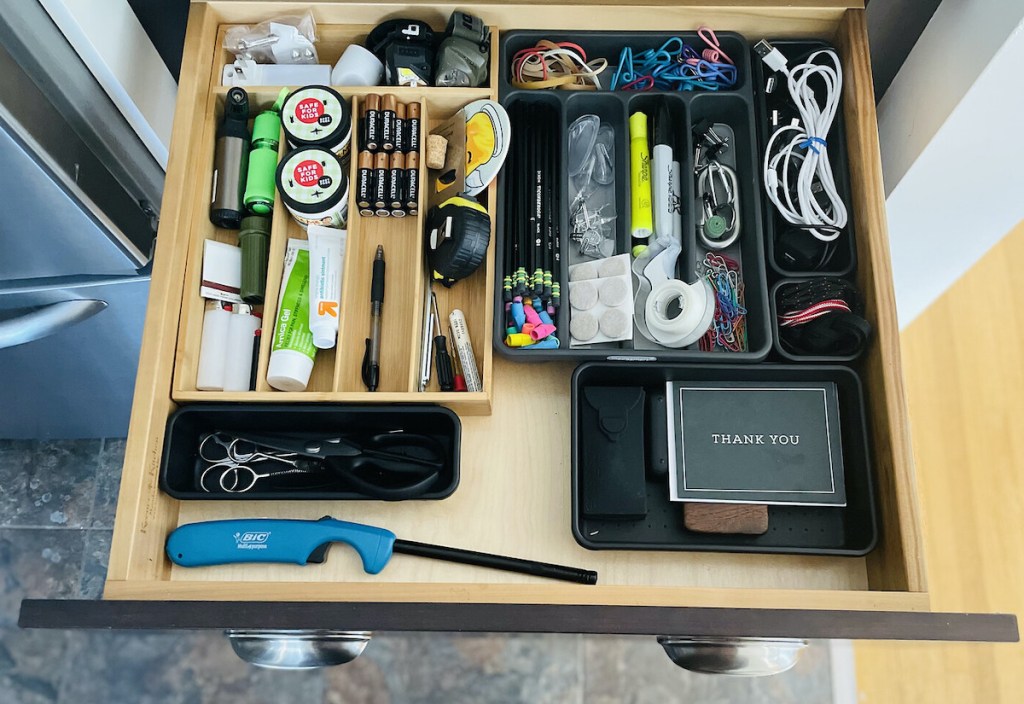 how to organize junk drawer with organizers and various stuff inside