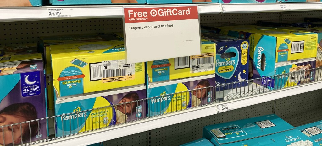 boxes of pampers overnight diapers on a target store shelf near promotional signage