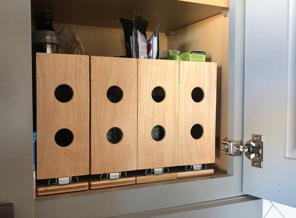 row of wood spice rack organizers inside kitchen cabinet