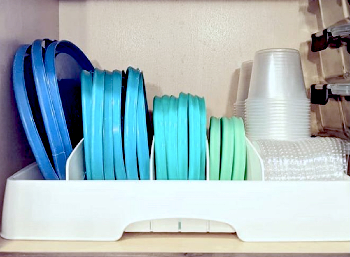 blue and green plastic lids in white storage organizer