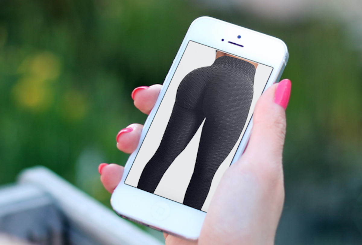 hand holding a phone with picture of black butt lifting leggings