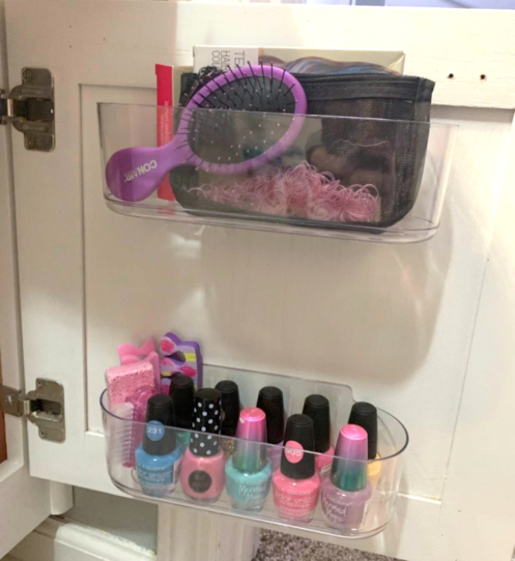 makeup and hair brush in clear self adhesive bins on back of cabinet door