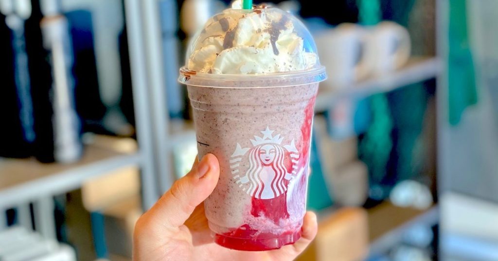 hand holding a starbucks blended frappuccino in store