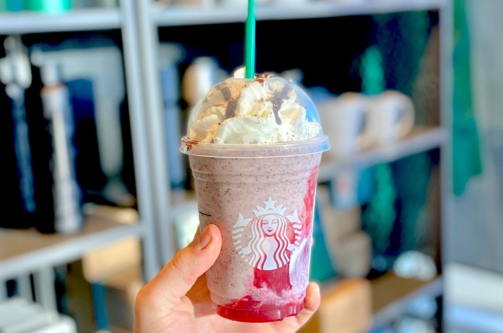 hand holding a starbucks blended frappuccino in store