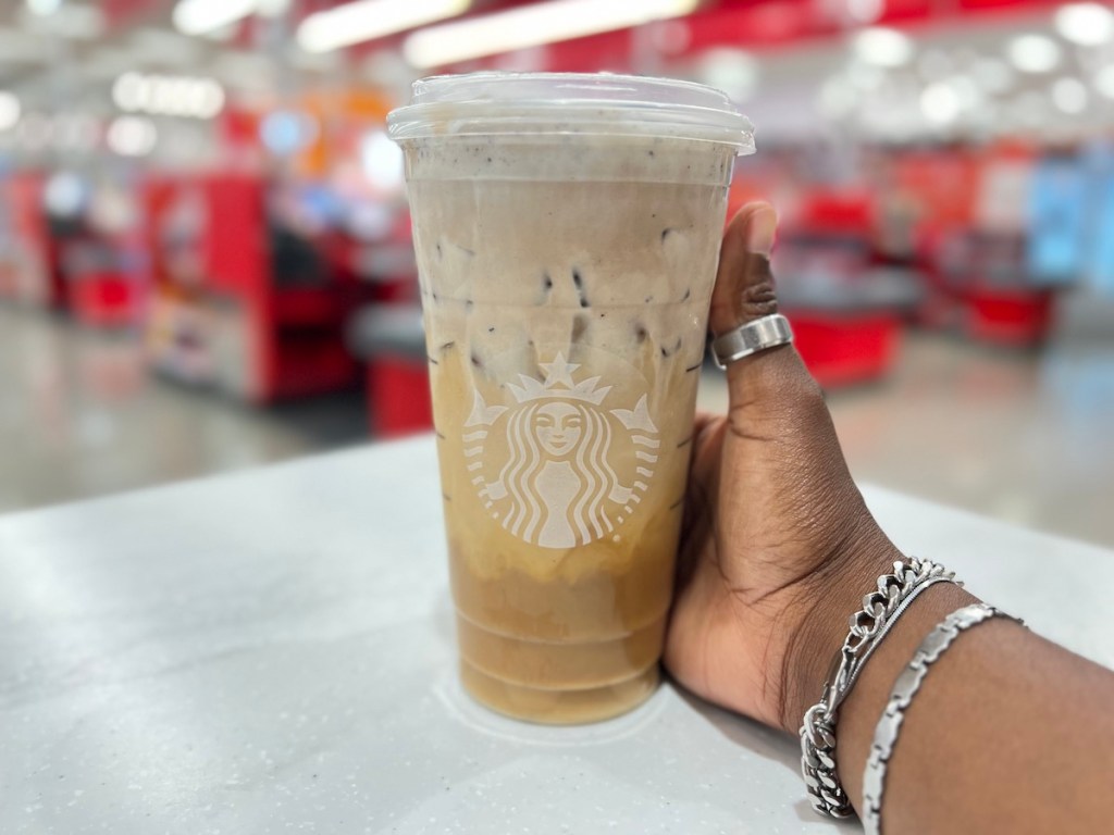 hand holding a starbucks cup with cold brew inside