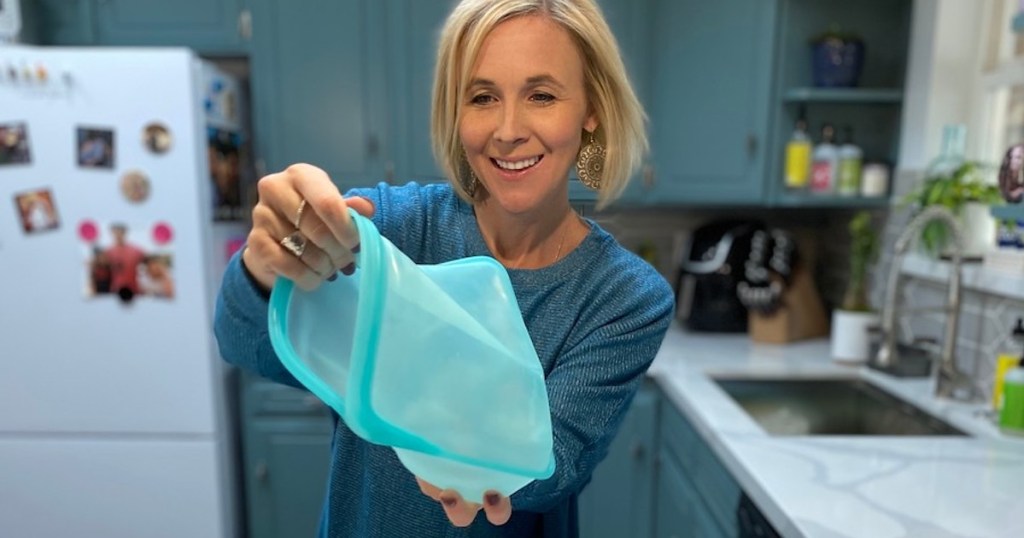 woman holding blue stasher bag open in kitchen